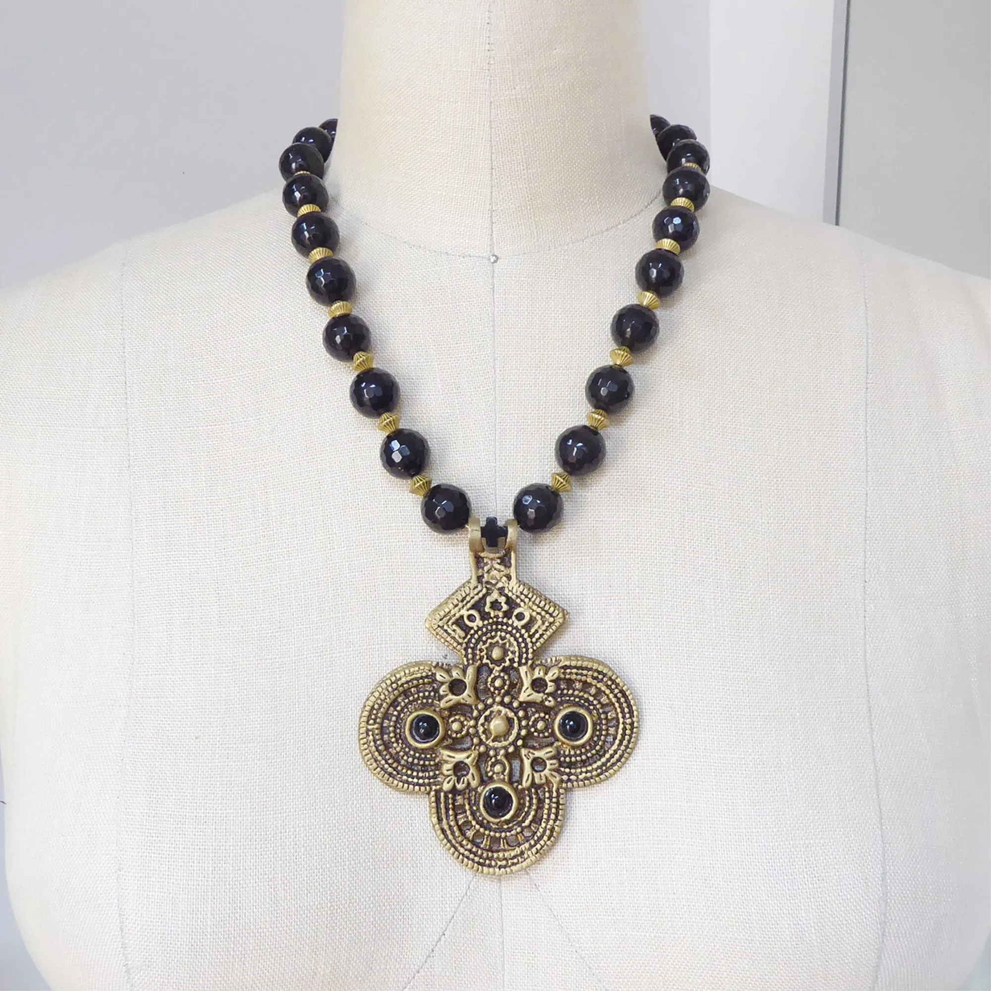 Black onyx and brass cross necklace