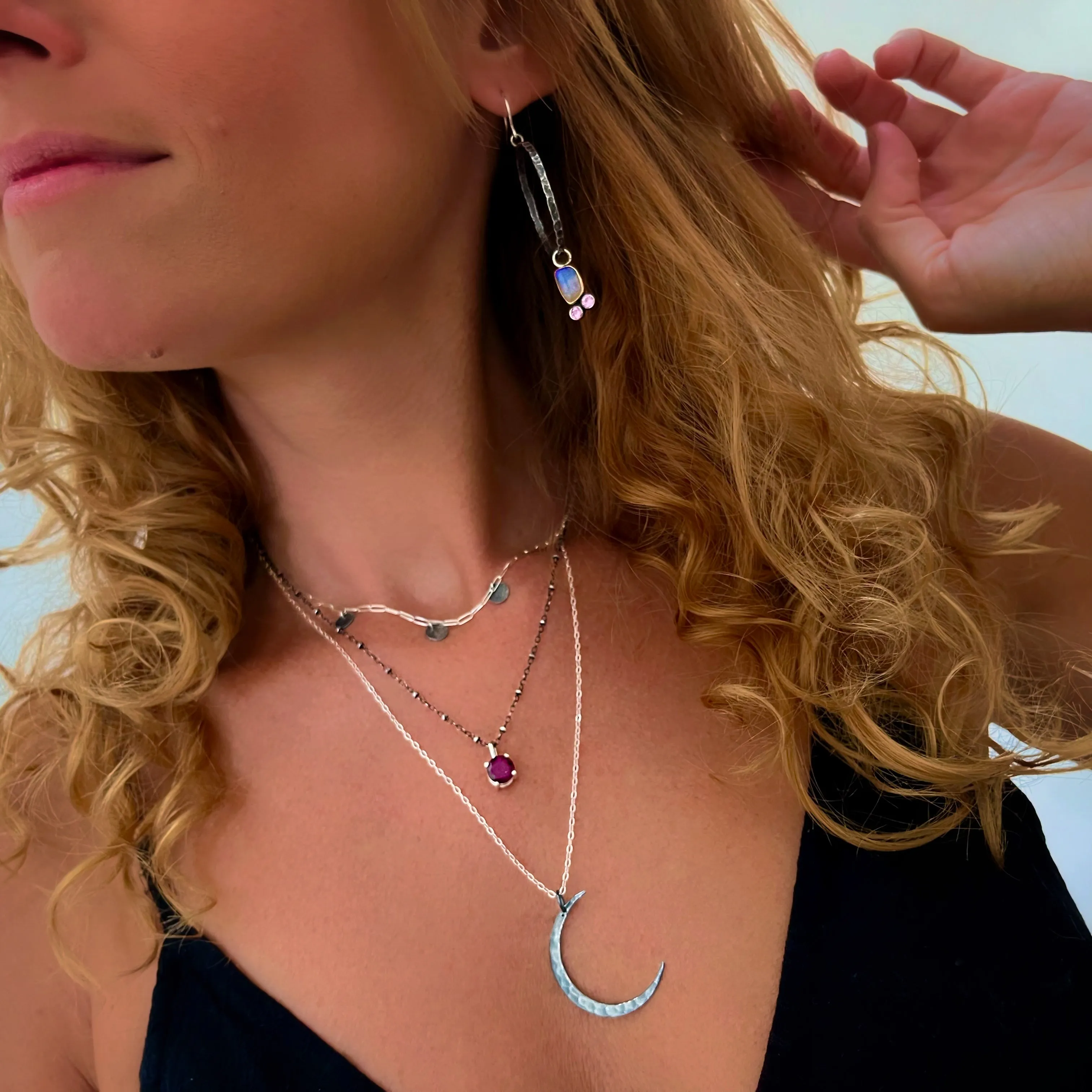 Layered moon necklace set with rhodolite garnet