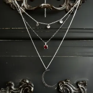 Layered moon necklace set with rhodolite garnet